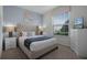Bedroom with a plush bed, nightstands, and large window at 8912 Sydney Ave, Kissimmee, FL 34747
