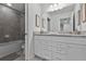 Bathroom with granite countertop, double vanity, and tiled shower/tub at 8912 Sydney Ave, Kissimmee, FL 34747