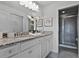 Bathroom with granite countertops, double sinks, and a walk-in shower at 8912 Sydney Ave, Kissimmee, FL 34747