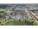 Aerial view of community with resort-style pool, clubhouse, and lake at 8912 Sydney Ave, Kissimmee, FL 34747