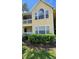 Condo building exterior with a yellow facade and lush landscaping at 1025 S Hiawassee Rd # 2216, Orlando, FL 32835