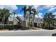 A yellow two-story condo building with palm trees and landscaping at 1025 S Hiawassee Rd # 2216, Orlando, FL 32835
