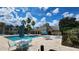 Community pool with lounge chairs and patio tables at 1025 S Hiawassee Rd # 2216, Orlando, FL 32835