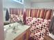 Clean bathroom with a shower/tub combo, a vanity, and polka-dotted shower curtain at 1053 Hemingway Dr, Deltona, FL 32725