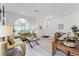 Spacious living area with hardwood floors, large windows, and a comfortable seating arrangement at 131 Cadiz Loop, Davenport, FL 33837