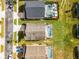 Aerial view of three houses with pools and landscaped yards at 131 Cadiz Loop, Davenport, FL 33837