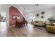 Bright living room with hardwood floors, a large sectional sofa, and access to a patio at 131 Cadiz Loop, Davenport, FL 33837