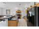 Open concept kitchen with stainless steel appliances and an island at 131 Cadiz Loop, Davenport, FL 33837