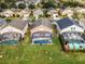 Aerial view showcasing houses with pools and lush green yards at 131 Cadiz Loop, Davenport, FL 33837