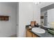 Bathroom with single sink vanity and dark countertop at 131 Cadiz Loop, Davenport, FL 33837