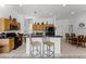 Open kitchen with island, stainless steel appliances, and wood cabinets at 131 Cadiz Loop, Davenport, FL 33837