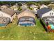 Aerial view of houses with private pools and screened enclosures at 131 Cadiz Loop, Davenport, FL 33837