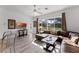 Relaxing Gathering room with a brown sectional sofa, large windows, and sliding doors to backyard at 131 Cadiz Loop, Davenport, FL 33837