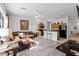 Open kitchen with wood cabinets, black appliances, and an island with seating at 131 Cadiz Loop, Davenport, FL 33837