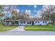 Ranch style home with carport, landscaped lawn and neutral exterior paint at 136 Alhambra Ave, Altamonte Springs, FL 32714