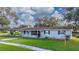 Newly painted light blue ranch home with carport and well-maintained lawn at 136 Alhambra Ave, Altamonte Springs, FL 32714