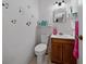 Clean bathroom with wood vanity and decorative accents at 136 Alhambra Ave, Altamonte Springs, FL 32714