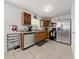 Stainless steel appliances and wood cabinets in this updated kitchen at 136 Alhambra Ave, Altamonte Springs, FL 32714