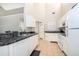 Kitchen with white appliances and granite counters at 1423 Farrindon Cir # 1423, Lake Mary, FL 32746
