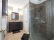 Updated bathroom with walk-in shower and dark vanity at 1423 Farrindon Cir # 1423, Lake Mary, FL 32746