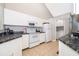 Kitchen with white cabinets and granite counters at 1423 Farrindon Cir # 1423, Lake Mary, FL 32746