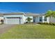 White house exterior with a two-car garage and landscaping at 15049 Canopy Cover Dr, Winter Garden, FL 34787