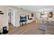 Living room with grey sofa, flat-screen TV, and laminate floors at 2216 Mystic Ring Loop, Poinciana, FL 34759