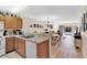 Open kitchen with stainless steel appliances and light wood cabinets at 2216 Mystic Ring Loop, Poinciana, FL 34759