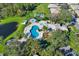 Community pool and spa with surrounding lush landscaping at 2216 Mystic Ring Loop, Poinciana, FL 34759