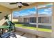 Screened porch with seating and backyard view at 2216 Mystic Ring Loop, Poinciana, FL 34759