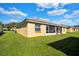 Back exterior of house with lush lawn at 2216 Mystic Ring Loop, Poinciana, FL 34759