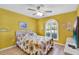 Bedroom with a bed, TV, and large window at 2216 Mystic Ring Loop, Poinciana, FL 34759