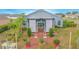 Brick patio with pergola, lush landscaping, and garden area at 2649 Sunset Cir, Lake Wales, FL 33898