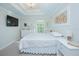 Spacious bedroom with a queen bed and mounted TV at 2649 Sunset Cir, Lake Wales, FL 33898