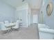 Open dining area with white table and chairs, and a white couch at 2649 Sunset Cir, Lake Wales, FL 33898