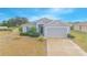 One-story home with gray siding, attached garage, and landscaping at 2649 Sunset Cir, Lake Wales, FL 33898