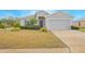 Single-story home with gray siding and a two-car garage at 2649 Sunset Cir, Lake Wales, FL 33898