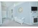 Living room with white couch, fireplace, and large clock at 2649 Sunset Cir, Lake Wales, FL 33898