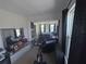 Main bedroom with sitting area, lake view, and exercise equipment at 2737 Nottel Dr, Saint Cloud, FL 34772