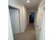 Long hallway with carpet and doors to bedrooms at 2737 Nottel Dr, Saint Cloud, FL 34772