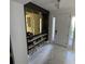 Elegant entryway with a geometric mirror, console table, and marble flooring at 2737 Nottel Dr, Saint Cloud, FL 34772
