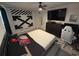Bedroom with Off-White closet doors, large bed, and gaming chair at 2737 Nottel Dr, Saint Cloud, FL 34772
