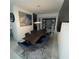 Formal dining room featuring a large wooden table, blue chairs, and modern art at 2737 Nottel Dr, Saint Cloud, FL 34772