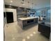 Modern kitchen with a large island, white cabinets, and quartz countertops at 2737 Nottel Dr, Saint Cloud, FL 34772