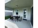 Covered patio with seating area overlooking the lake at 2737 Nottel Dr, Saint Cloud, FL 34772