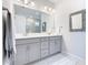 Double vanity bathroom with modern gray cabinets at 445 Via Abruzzi St, Poinciana, FL 34759