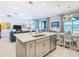 Open kitchen with island, stainless steel appliances, and breakfast bar at 445 Via Abruzzi St, Poinciana, FL 34759