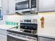 Modern kitchen with stainless steel stove and microwave at 445 Via Abruzzi St, Poinciana, FL 34759