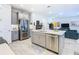 Updated kitchen features stainless steel appliances and a large island with seating at 445 Via Abruzzi St, Poinciana, FL 34759