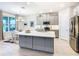 Modern kitchen with gray cabinets, stainless steel appliances, and a large island at 445 Via Abruzzi St, Poinciana, FL 34759